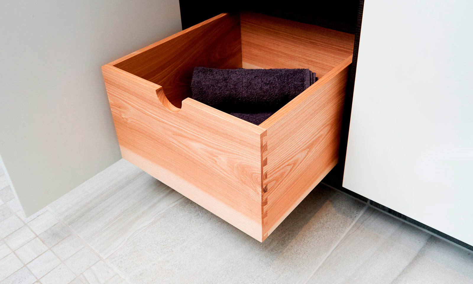 Bespoke modern ensuite vanity unit, hand finished in matt white paint, designed with rounded corners and push to open doors. Contemporary hand-crafted furniture from our skilled cabinet makers at Mounts Hill Woodcraft.