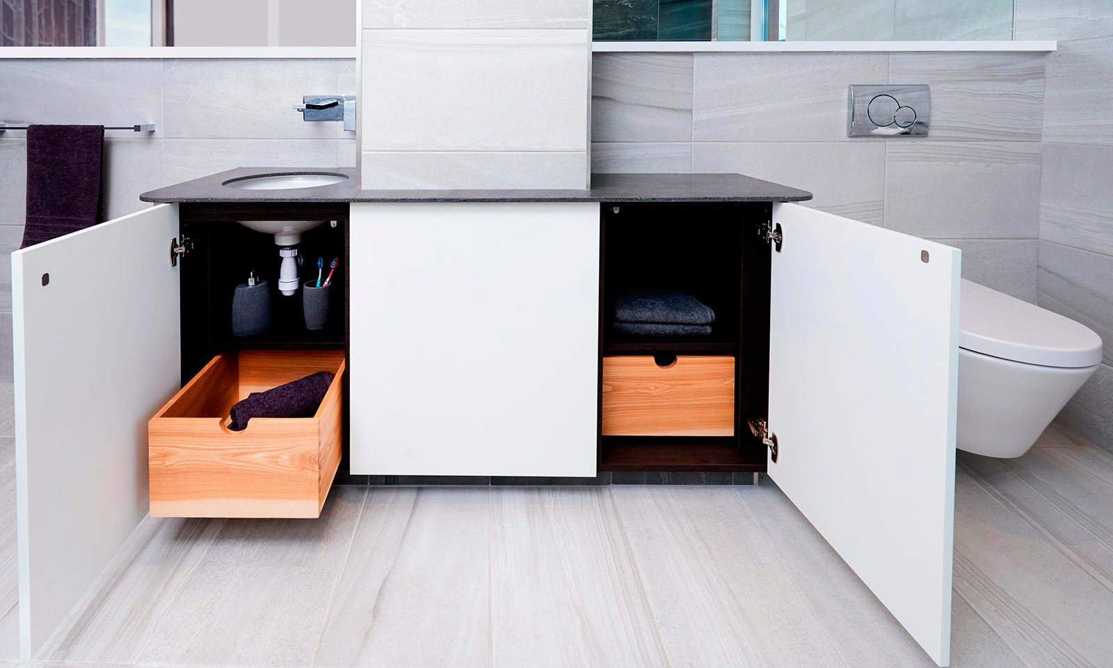 Bespoke modern ensuite vanity unit, hand finished in matt white paint, designed with rounded corners and push to open doors. Contemporary hand-crafted furniture from our skilled cabinet makers at Mounts Hill Woodcraft.