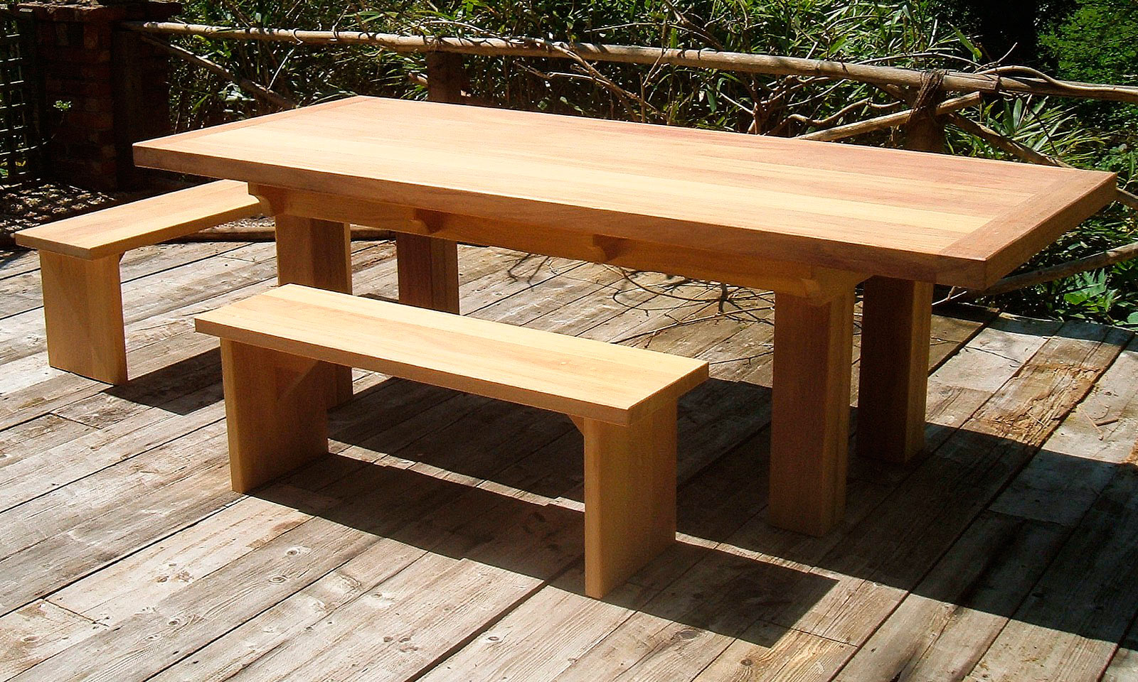 Iroko Table, with matching bench seats. A bespoke, handmade garden table manufactured out of Iroko hardwood. Quality hand-crafted exterior furniture designed and built by Mounts Hill Woodcraft.