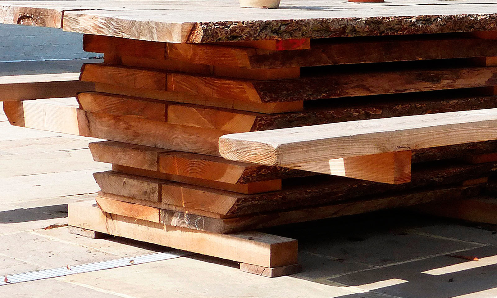 Milk House Table. A bespoke, unique 7m garden table that seats 35 people and is installed at the Milk House pub in Sissinghurst. Handmade using a whole Douglas Fir tree and manufactured by the skilled joiners at Mounts Hill Woodcraft.