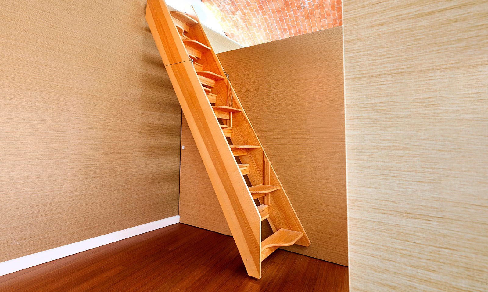 Fold out staircase. Bespoke, custom made, hand-crafted, hardwood timber steps to access a storage area at 'Crossway', a para 55 eco-house. Featured on Grand Designs, these steps are cleverly mounted to the back of an internal room divider and were installed by the skilled joiners at Mounts Hill Woodcraft.