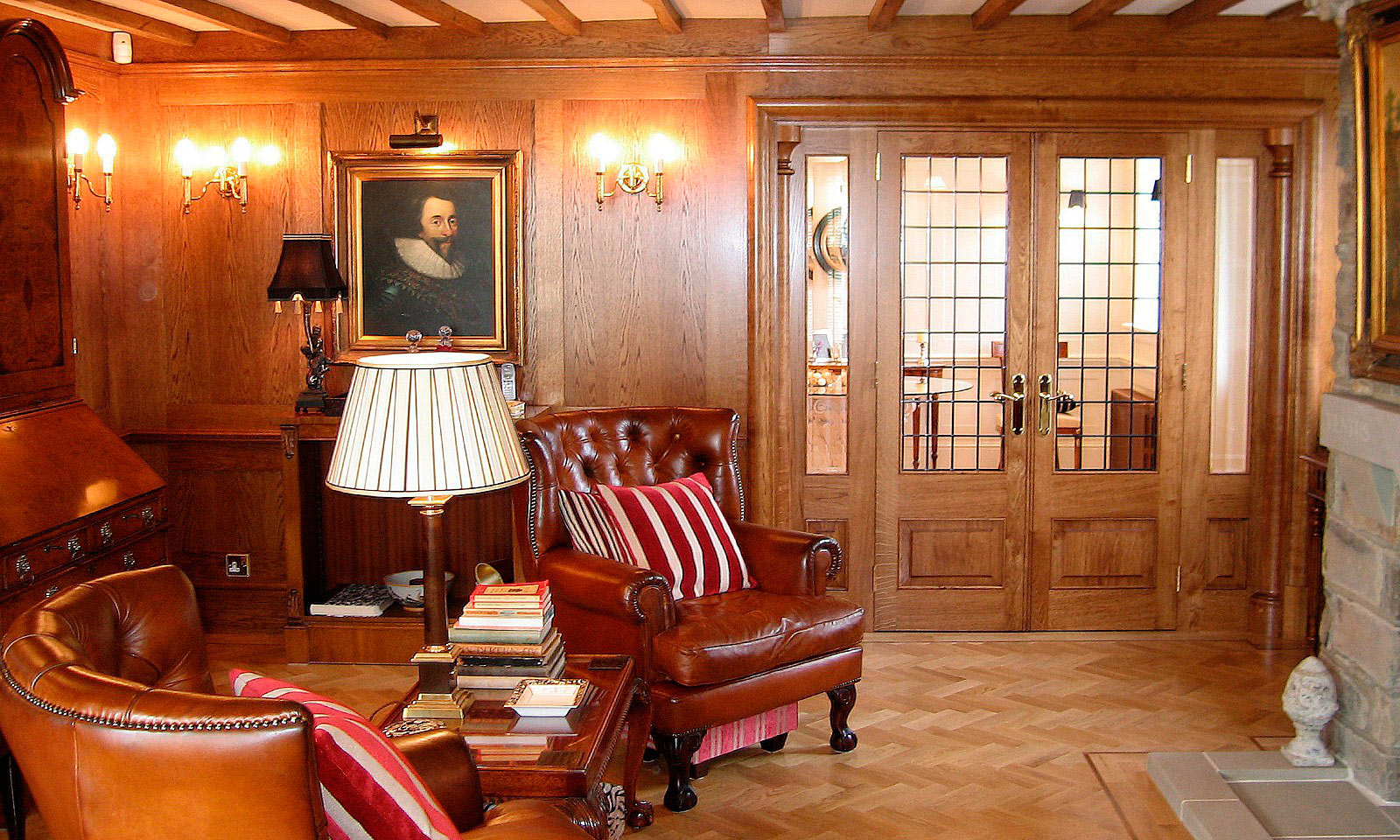 Oak panelled drawing room. Bespoke, custom made, traditional hardwood panelling, pediments, architraves and balusters, manufactured and installed by the skilled joiners at Mounts Hill Woodcraft.