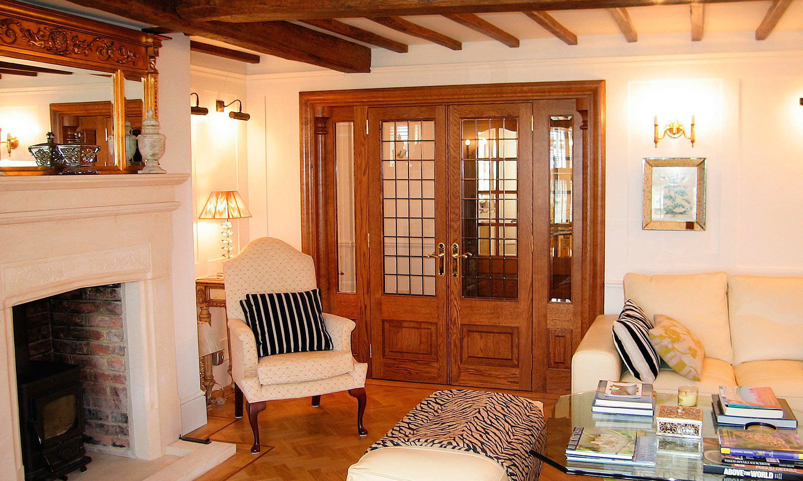 Oak panelled drawing room. Bespoke, custom made, traditional hardwood panelling, pediments, architraves and balusters, manufactured and installed by the skilled joiners at Mounts Hill Woodcraft.