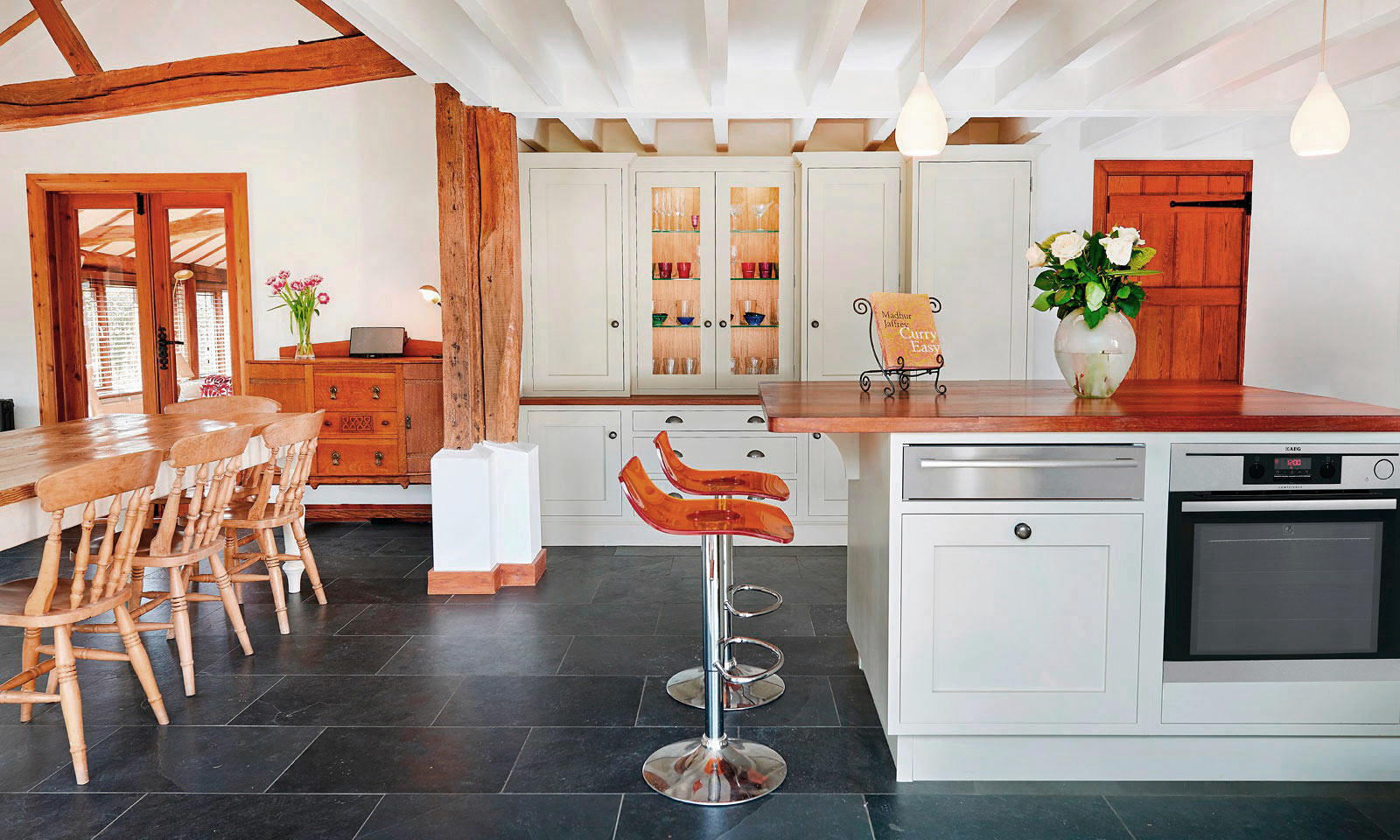 Golford. A classic handmade, hand-painted, Shaker style kitchen, installed in a large barn. A bespoke hand-crafted kitchen manufactured by the skilled cabinet makers at Mounts Hill Woodcraft.