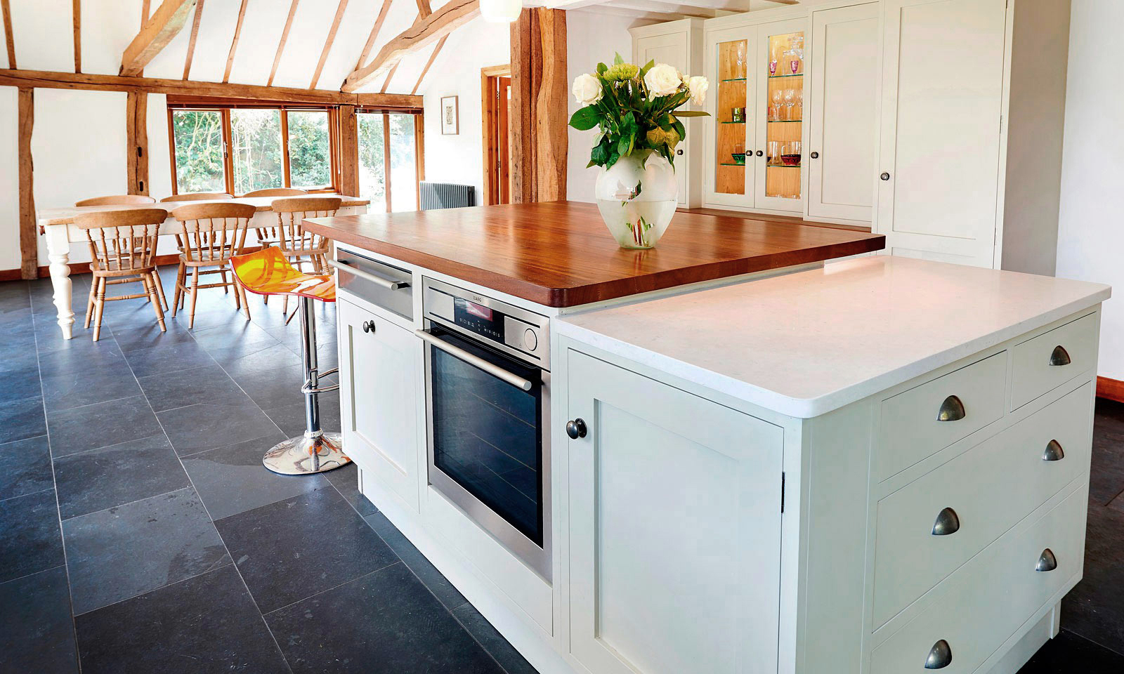 Golford. A classic handmade, hand-painted, Shaker style kitchen, installed in a large barn. A bespoke hand-crafted kitchen manufactured by the skilled cabinet makers at Mounts Hill Woodcraft.